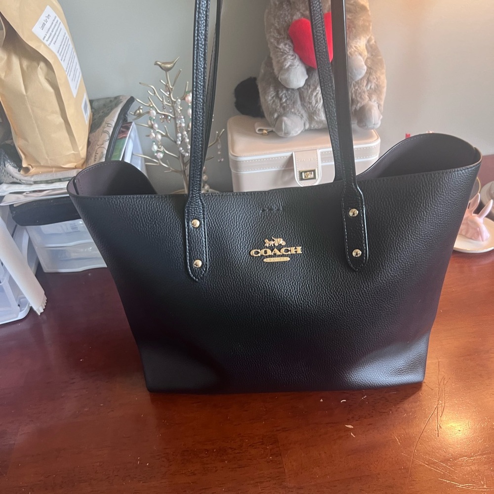 Barely used Black Town Coach Tote with Burgundy interior.